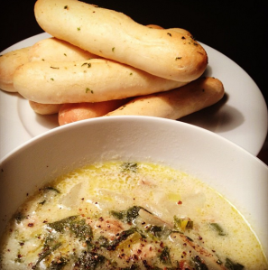 soup bowl with breadsticks on the side